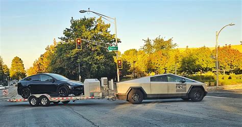 Tesla Cybertruck seen towing a Model Y on a trailer in California