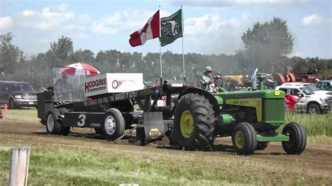 John Deere 830 tractor pulling at an antique tractor pull competition. - YouTube
