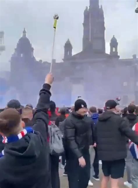 Moment reckless Rangers fan sets off firework in packed George Square ...