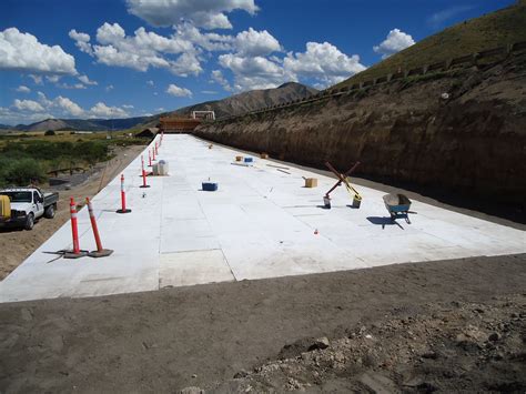 construction is underway on the side of a road near a mountain range ...