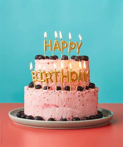 "Happy Birthday Cake With Lit Candles." by Stocksy Contributor "Martí Sans" - Stocksy