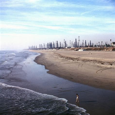 Color photograph of Huntington Beach with oil wells, 1956.