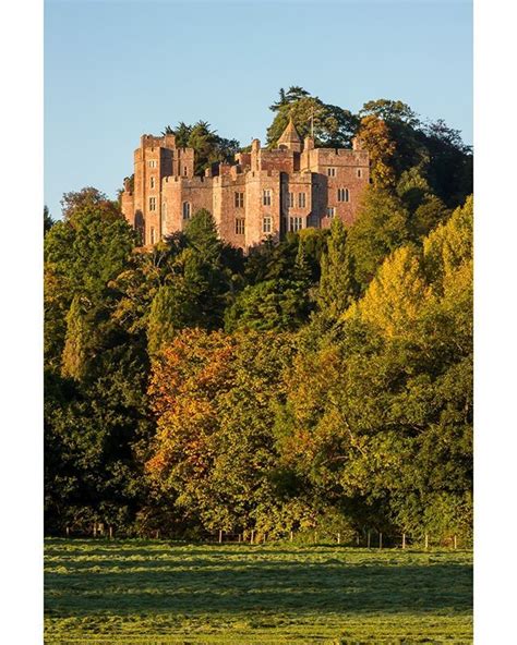 Dunster Castle in the Autumn Sun. Dunster Castle is a former motte and ...