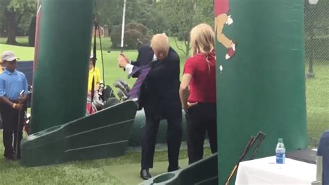 Trump practices his golf swing at White House sports fitness event