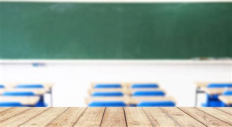 Premium Photo | Empty wooden desk space platform with school classroom background for product ...