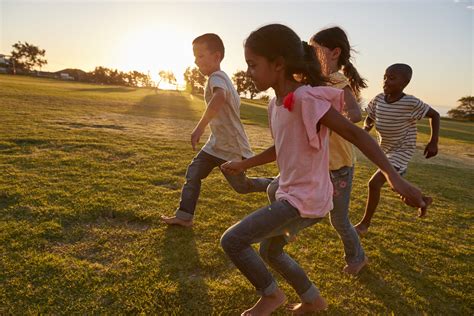 Four children running barefoot in a park - The Center Within