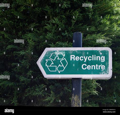 Waste recycling sign pointing to recycling centre Stock Photo - Alamy