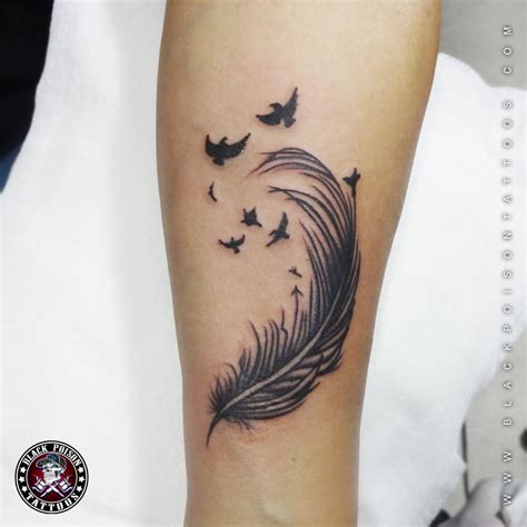 The black feather tattoo above looks cool on the arm and very simple ...