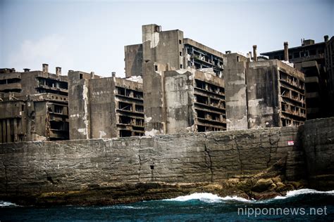 Tourists visit the abandoned island of Gunkanjima or “Battleship Island ...