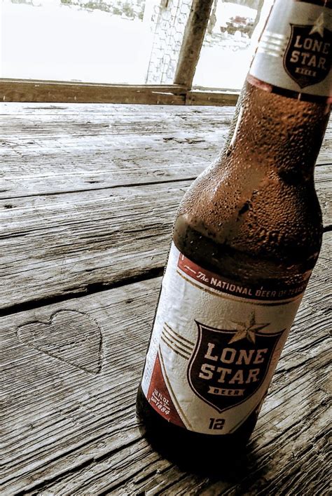 a beer bottle sitting on top of a wooden table