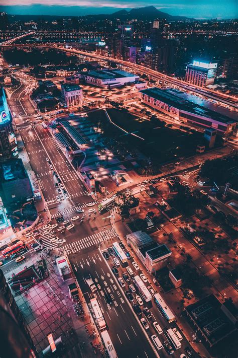 an aerial view of a city at night with traffic and buildings in the ...