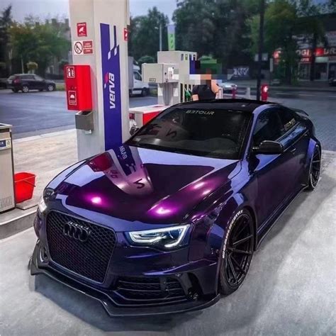 a purple car is parked at a gas station