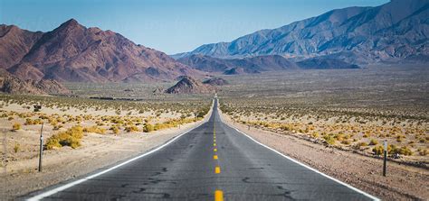 "Long Straight Road In The Desert Leading Off Into The Mountains" by Stocksy Contributor ...