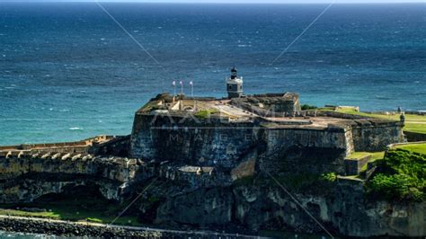 Historic fort along the coast resting on clear blue water, Old San Juan ...