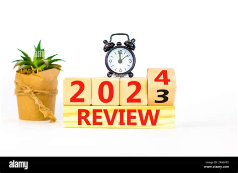 2024 review new year symbol. Businessman turns a wooden cube and ...