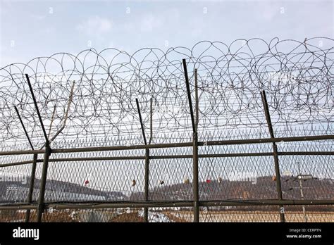 Barbed wire fence and South Korean flag at the DMZ, De-militarised Zone on the South North ...