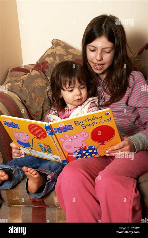 Sisters reading a Ladybird Peppa Pig book Stock Photo - Alamy