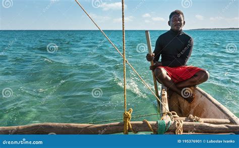 Anakao, Madagascar - May 03, 2019: Unknown Malagasy Fisherman Sitting on Back of His Piroga ...