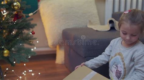 Excited Curious Little Girl Smiling, Opening Christmas Gifts ...