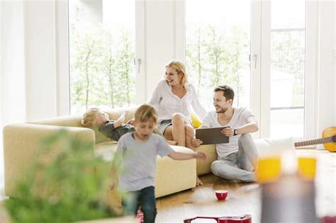 Happy family with two sons in living room of their new home stock photo