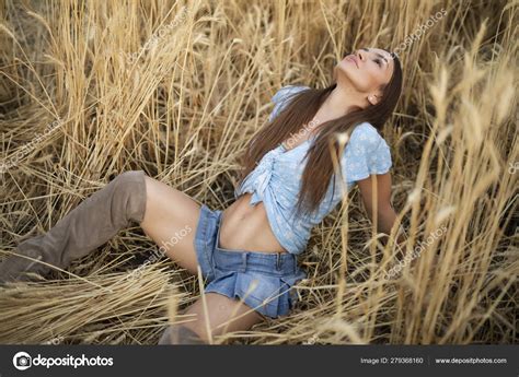 Sexy peasant woman in mini skirt sitting on wheat field Stock Photo by ©antgor90 279368160