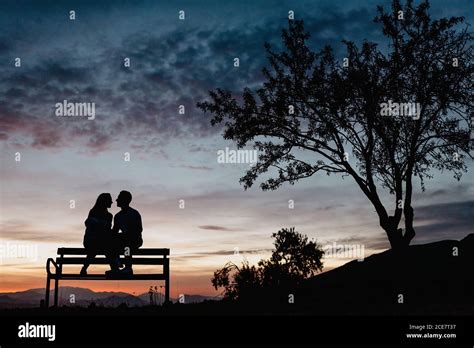 Silhouette couple sitting bench sunset bench hi-res stock photography and images - Alamy