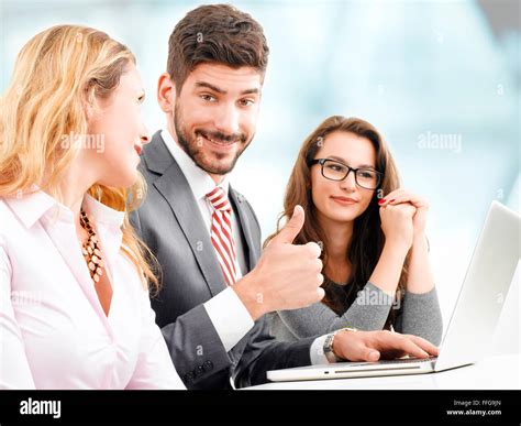 smiling businessman showing thumbs up in office Stock Photo - Alamy