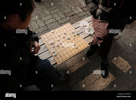 Korean men playing a strategy board game called Janggi changgi or jangki, sometimes called ...