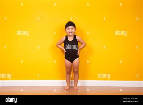 Little girl wearing beach outfit on yellow background. Summer and ...