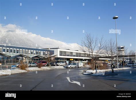 Innsbruck, Tyrol, Austria, Europe. Airport arrivals terminal building close to the mountains in ...