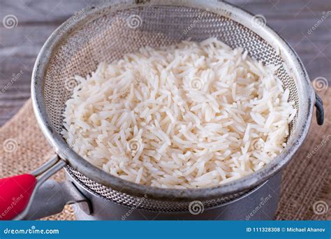 Colander with Rice in Saucepan on Wooden Board Stock Photo - Image of agriculture, heap: 111328308