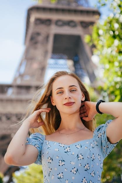 Premium Photo | Cheerful and happy girl near the eiffel tower in paris