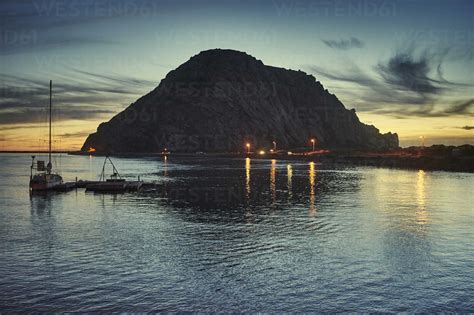 Silhouetted view of Morro Bay Rock at sunset, Morro Bay, California ...