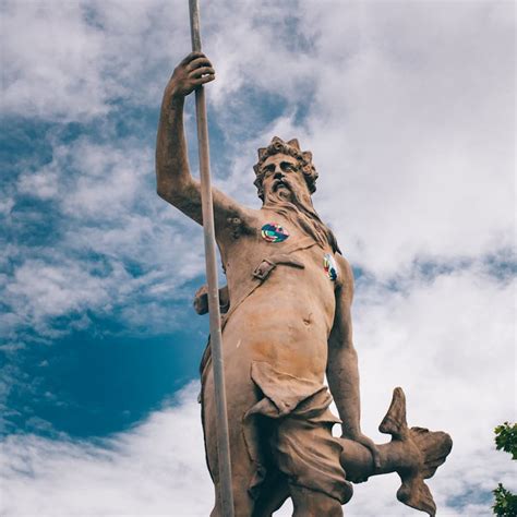 Statue of Neptune against blue sky · Free Stock Photo