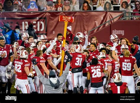 Wisconsin celebrates with the Paul Bunyan Axe Trophy after beating ...