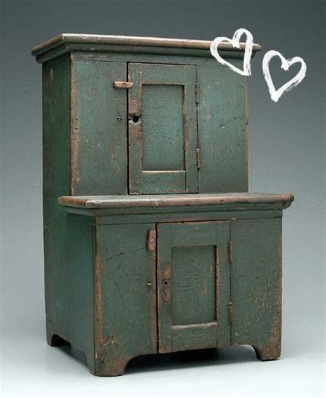 an old green wooden cabinet with two doors and one door open on the top ...