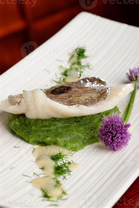 John Dory fish fillet on spinach puree 736007 Stock Photo at Vecteezy