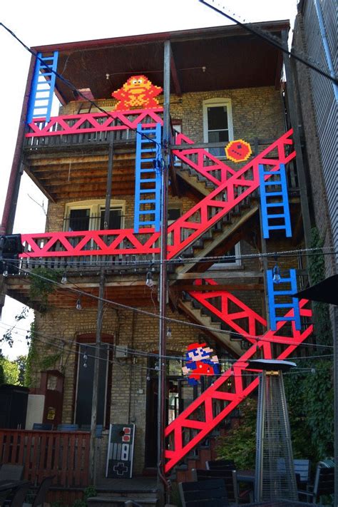 a red and blue fire escape next to a brick building