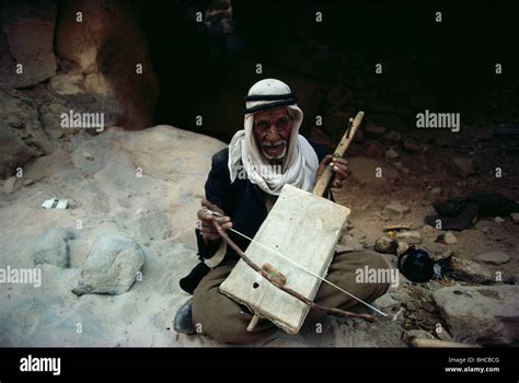 An old man plays his instrument Stock Photo - Alamy