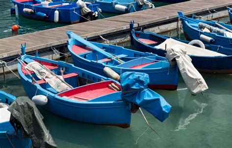 Premium Photo | Fishing boats in a harbor in italy