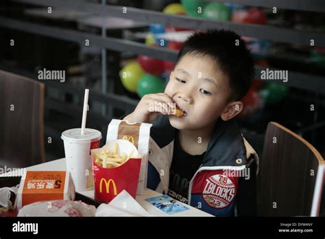 A kid eat in a Mcdonalds restaurant Stock Photo - Alamy