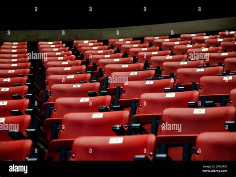 Modern conference room full of red plastic seats Stock Photo - Alamy