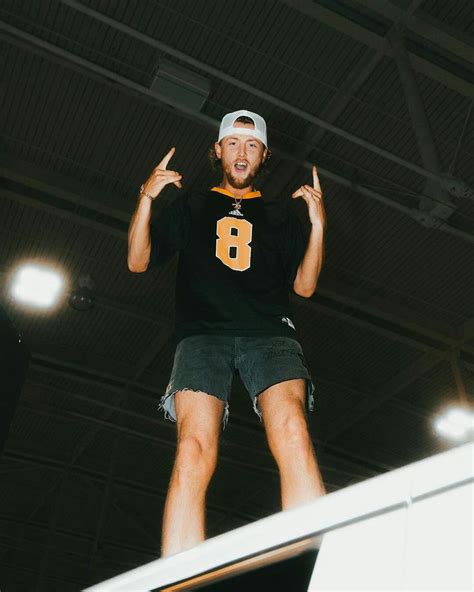 a man standing on top of a skateboard in the air