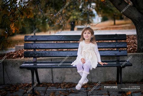 Girl sitting on a bench in the park, Bulgaria — autumn, preschooler - Stock Photo | #238383850