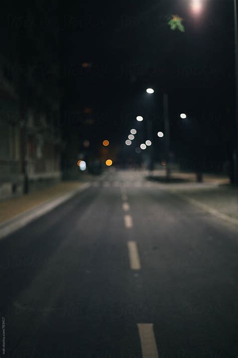 "Empty Street During The Night. Blurry." by Stocksy Contributor "Mak" - Stocksy