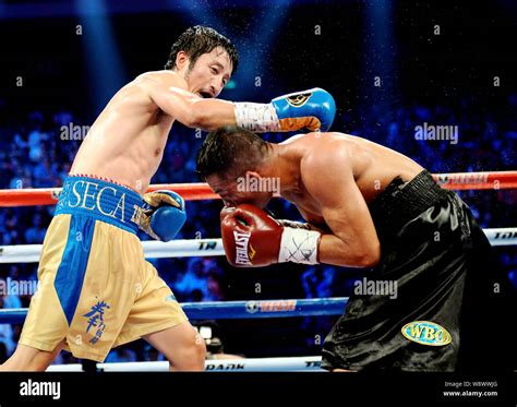 --FILE--Chinese boxer Zou Shiming, left, fights with Luis De La Rosa of Colombia in their ...