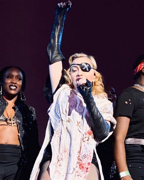 madonna performing on stage with other female dancers in the background ...