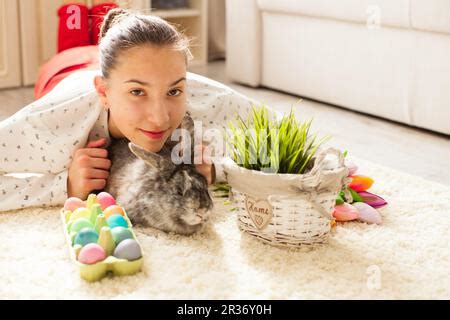 Easter eggs in box and greeting card on wooden table. Top view with ...