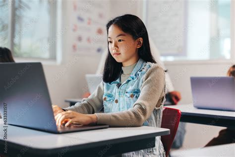 Exploring the digital world: Girl programming on a laptop in a coding class Stock Photo | Adobe ...