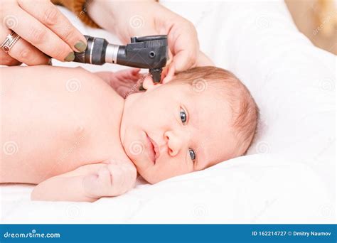 Newborn ENT Exam - Doctor Checking Ear with Otoscope in Pediatric ...